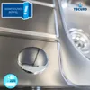 Close-up of a stainless steel sink with a chrome stopper and branding elements. Produktbild-Vorschau