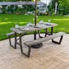 A picnic table set up in a backyard with place settings and an umbrella. Produktbild-Vorschau