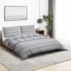 A bedroom scene with a bed, bedding, and a nightstand. Produktbild-Vorschau