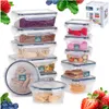 A collection of Vilde food storage containers filled with various food items, presented with fresh fruit and berries in the background. Náhled obrázku produktu