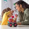 A mother and child are playing with a toy fire truck. Produktbild-Vorschau
