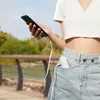 A person holding a smartphone while outdoors. Produktbild-Vorschau
