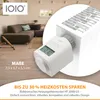 A living room setting with a sofa and a close-up of a white heating thermostat attached to a radiator. Produktbild-Vorschau