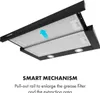 Underside view of a black under-cabinet range hood with its pull-out mechanism extended, showing the grease filters and LED lights. An arrow indicates airflow direction. Podgląd zdjęcia produktu