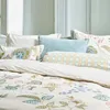 A bed with multiple pillows and bedding. Produktbild-Vorschau