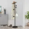 A coat rack with a coat, hat, and bag on it, placed next to a cabinet and a plant. Produktbild-Vorschau