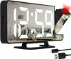 A digital alarm clock with a projector, showing a reflection of a living room. Náhled obrázku produktu