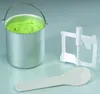 An ice cream maker bowl with green ice cream, a mixing paddle, and a spoon. Voir les images du produit
