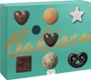 A box of assorted chocolates and cookies with a teal background and gold lettering. Náhled obrázku produktu