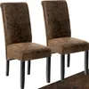 Two brown upholstered dining chairs with black legs are shown against a white background. Náhled obrázku produktu