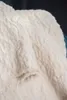 A close-up view of a soft, cream-colored blanket with a textured pattern. Produktbild-Vorschau