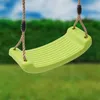 A close-up of a lime green swing seat hanging from brown ropes against a blurred green hedge and blue sky background. Anteprima dell’immagine prodotto