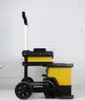 A side view of a rolling tool cart with yellow storage bins against a white brick wall. Voir les images du produit