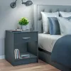 A bedside table next to a bed in a bedroom. Produktbild-Vorschau
