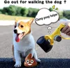 A dog is sitting next to a poop scooper and a cartoon poop emoji. Produktbild-Vorschau