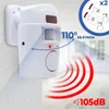 A white motion sensor alarm with red signal waves emanating from it and two remote controls in the upper right corner. Voir les images du produit