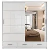 A white sliding door wardrobe with a mirrored section reflecting a bedroom interior. Voir les images du produit