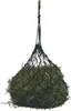 A black hay net filled with hay, suspended from a rope. Produktbild-Vorschau