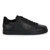 A black leather sneaker shown from the side against a white background. Voir les images du produit