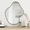 A mirror on a dresser with various cosmetic items. Podgląd zdjęcia produktu