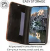 A flip-style phone case is open, showing the inside with a card slot and the phone screen displaying a landscape image. Podgląd zdjęcia produktu