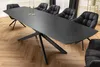 A modern dining room with a large extendable table and upholstered chairs. Produktbild-Vorschau