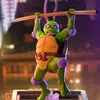 A statue of Donatello from Teenage Mutant Ninja Turtles holding a bo staff. Podgląd zdjęcia produktu