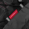 A close-up view of a red tag on a black backpack. Anteprima dell’immagine prodotto