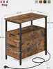 A side view of a wooden nightstand with black metal legs, showing dimensions and features like drawers and a power strip. Náhled obrázku produktu