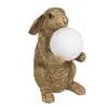 A gold-colored rabbit figurine holding a white orb, presented against a white background. Náhled obrázku produktu