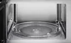 Interior view of a microwave oven showing the turntable. Voir les images du produit
