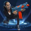 A young person is crouching and holding a toy gun. Anteprima dell’immagine prodotto