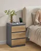 A bedside table next to a bed, with a person sitting in bed. Produktbild-Vorschau