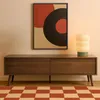 A modern living room scene featuring a TV cabinet, artwork, and a lamp. Voir les images du produit