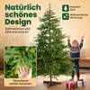 A young boy stands happily next to a large artificial Christmas tree, with gift boxes at its base. A close-up of the tree's branches is shown in a inset box. Produktbild-Vorschau