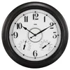 A close-up view of a large, round wall clock with a black frame, white face, and black numerals. The clock includes a thermometer and a hygrometer. Produktbild-Vorschau