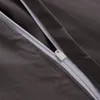 A close-up view of a zipper on a dark gray fabric. Produktbild-Vorschau