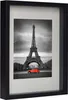 A framed black and white photograph of the Eiffel Tower with a red vintage car in the foreground. Produktbild-Vorschau