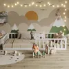 A child's bedroom with a bed, toys, and a mural. Anteprima dell’immagine prodotto