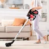 A person is vacuuming a carpeted floor in a living room with a sofa and fireplace in the background. Podgląd zdjęcia produktu