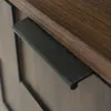 A close-up view of a drawer handle on a wooden cabinet. Produktbild-Vorschau