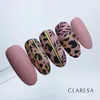 A set of five artificial nails with a matte pink base color and leopard print and leaf designs with gold accents. Anteprima dell’immagine prodotto