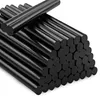 A pile of black hot glue sticks. Voir les images du produit