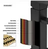 A cutaway view of a black faucet showing its layered construction, with a pile of brass pipes in the lower left corner. Produktbild-Vorschau