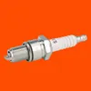 A single spark plug is shown against an orange background. Náhľad obrázku produktu