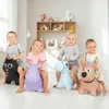 Four children are playing on inflatable animals in a room with shelves of stuffed animals in the background. Anteprima dell’immagine prodotto