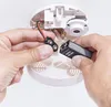 Hands installing a 9V battery into a smoke detector. Produktbild-Vorschau