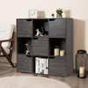 A gray wooden bookshelf with 9 compartments, some of which have doors, is shown in a room with a chair and a rug. Náhľad obrázku produktu