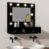 A black vanity mirror with LED lights and a shelf, mounted above two sinks with black faucets. Produktbild-Vorschau