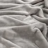 A close-up, textured view of a soft, gray blanket. Produktbild-Vorschau